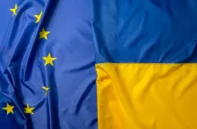 Flags of Ukraine and European Union folded together close up