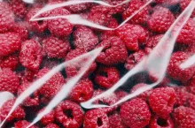 Frozen raspberries in plastic pack, top view