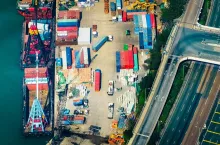 Aerial view cargo ships loaded by crane with cargo containers at a busy port terminal. Hong Kong