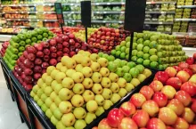 Stall with red and green fresh apples in rows in supermarket