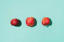 Ugly fruits concept. Organic red apples on blue background. The concept of ecology, not plastic. Healthy food. Copy space. Top view. Zero waste concept.